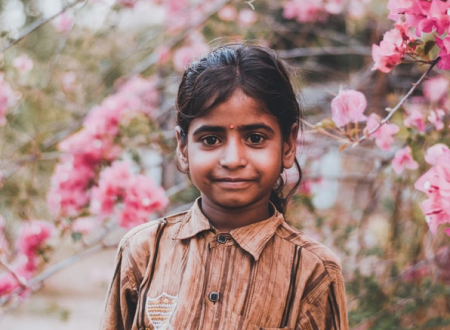 girl in front of flowering tree