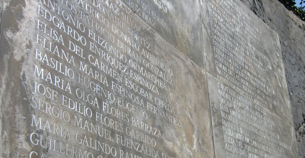 A wall with names carved into the stone, a memorial for the detained, disappeared, and executed in Santiago, Chile