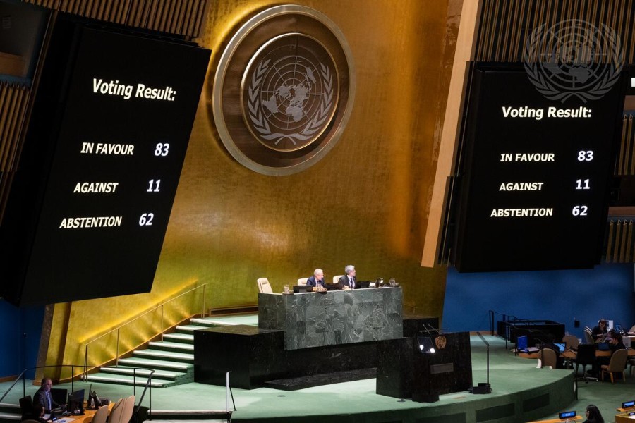 People are assembled in the UN General Assembly chamber in New York and large screen shows a voting result, with 83 in favor, 11 against, and 62 abstentions.  