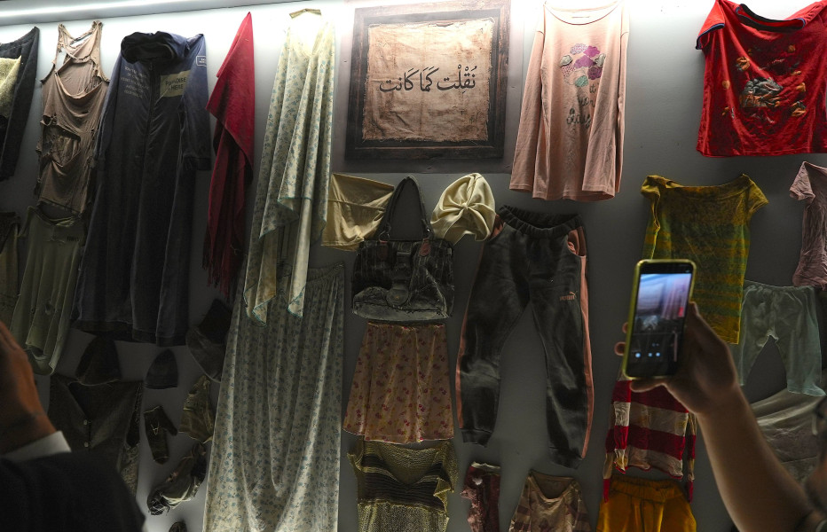Articles of clothing hang inside a display case