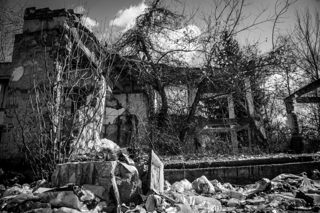 The ruins of a building with trees growing in it.
