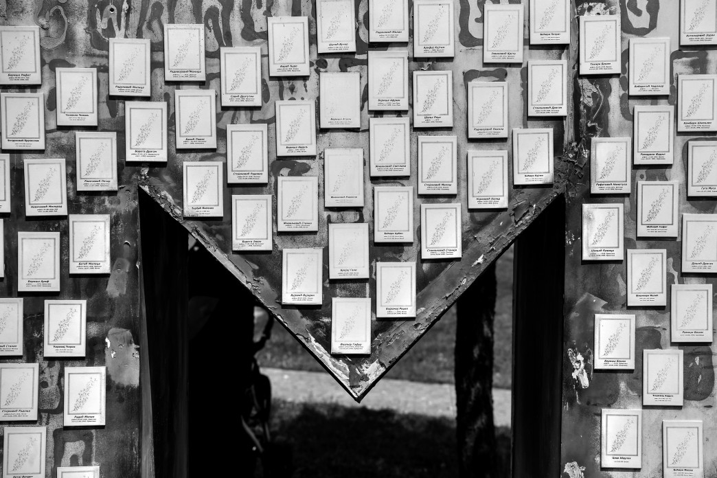 Plaques with the names of people adorn a monument.