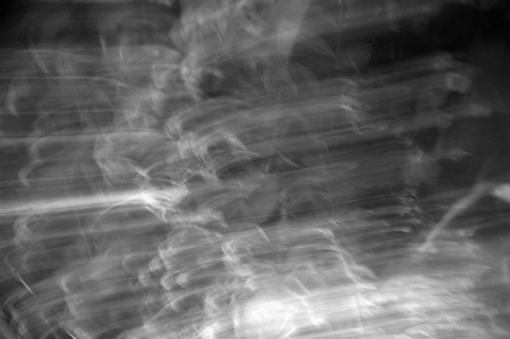 A long exposure of lights with light trails in black and white.