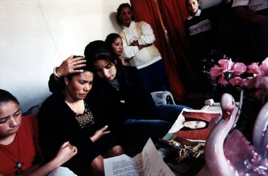 A family wearing black crying.
