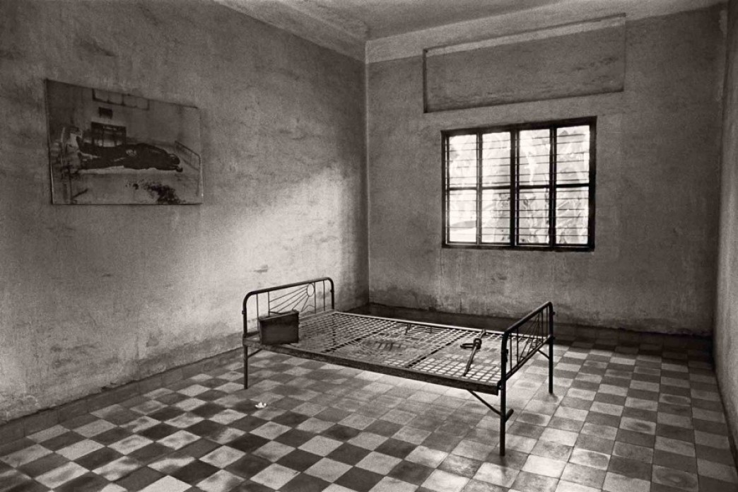 A bed frame in an empty room.