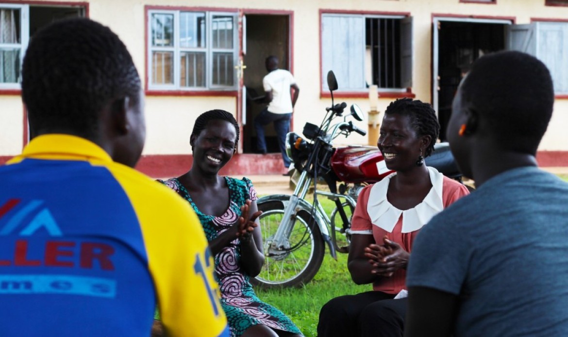 A group meeting in a circle outside.