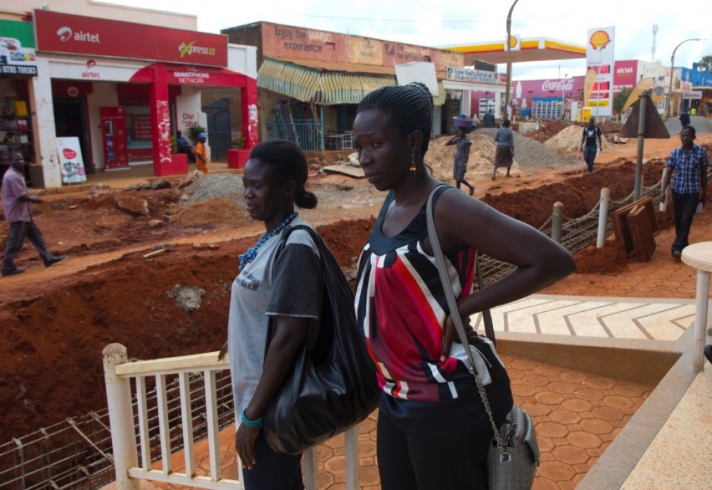 Two women looking out onto the street.
