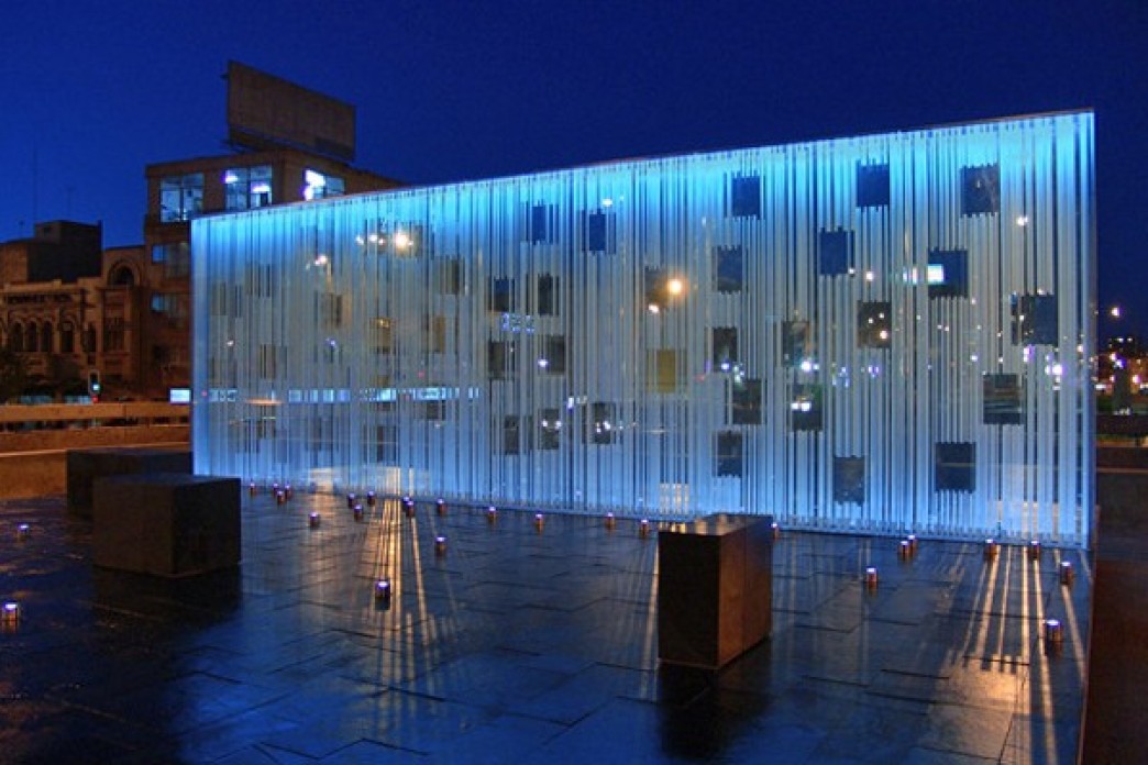 A glass monument illuminated.