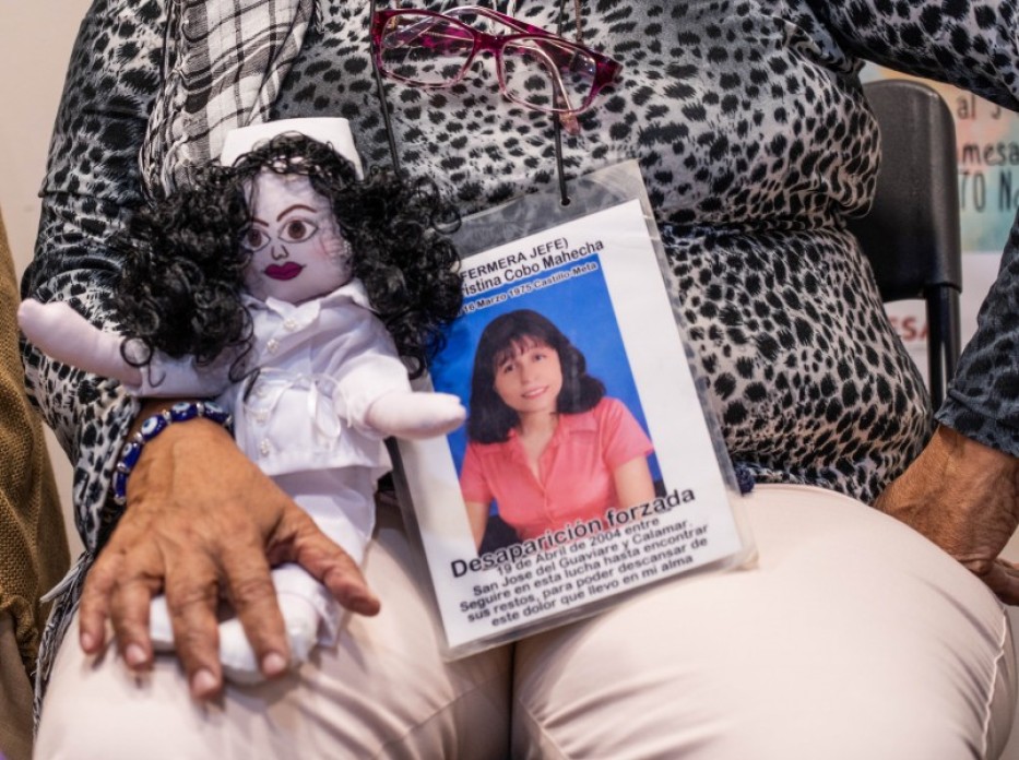 A woman with a doll in her lap.
