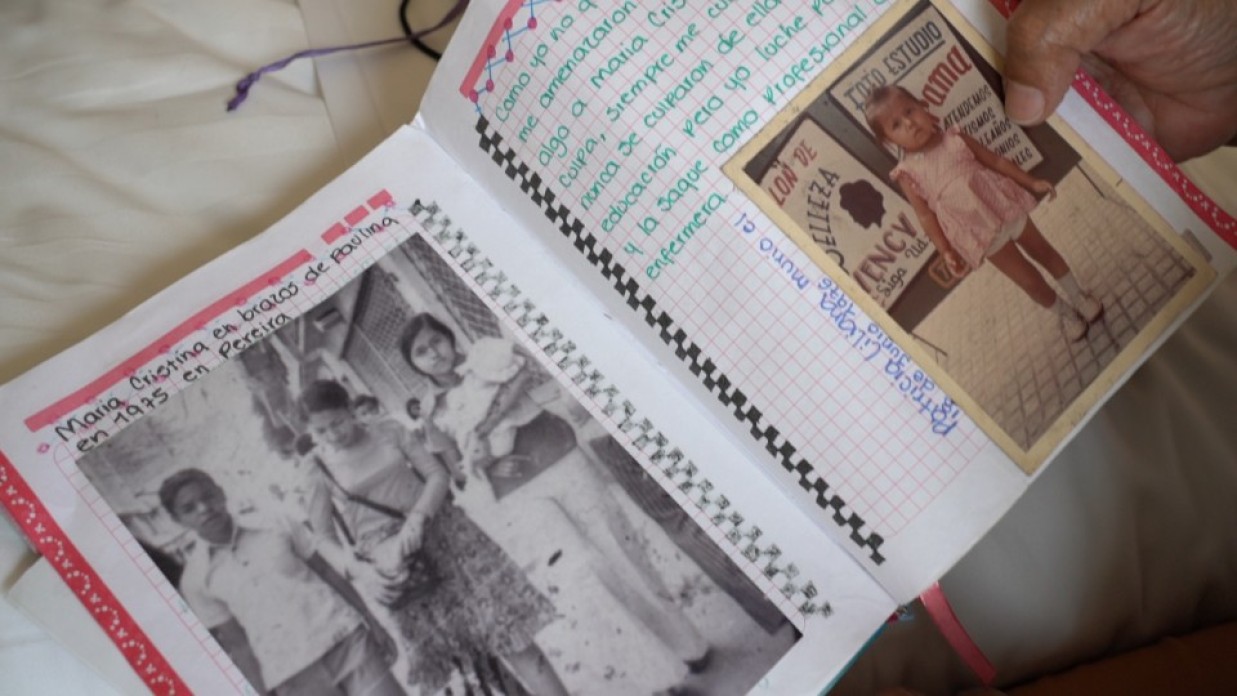 A notebook filled with writing and photos.