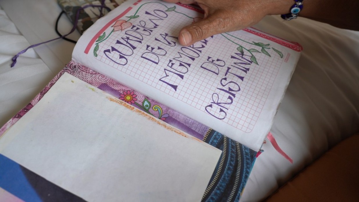 Open notebook filled with handwriting and photos.