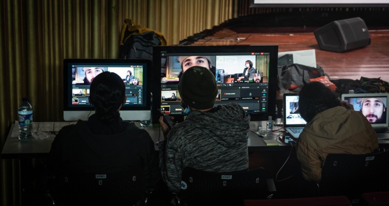 People sitting at a desk with computers.
