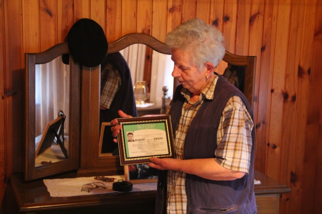 A woman holding a photograph.
