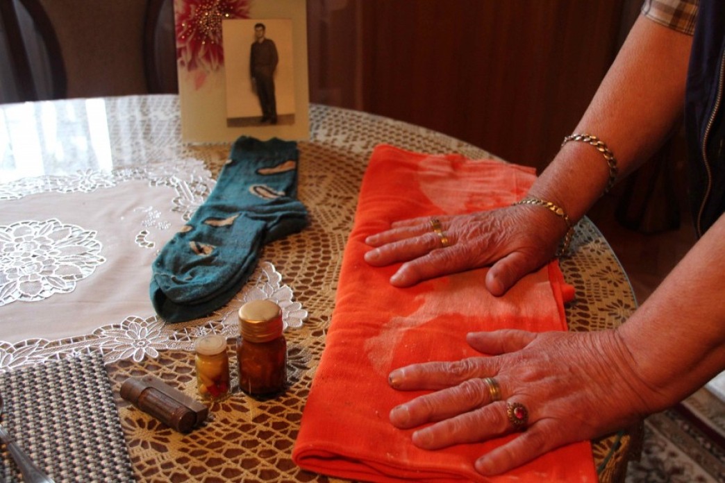 A woman's hands touching a piece of fabric.