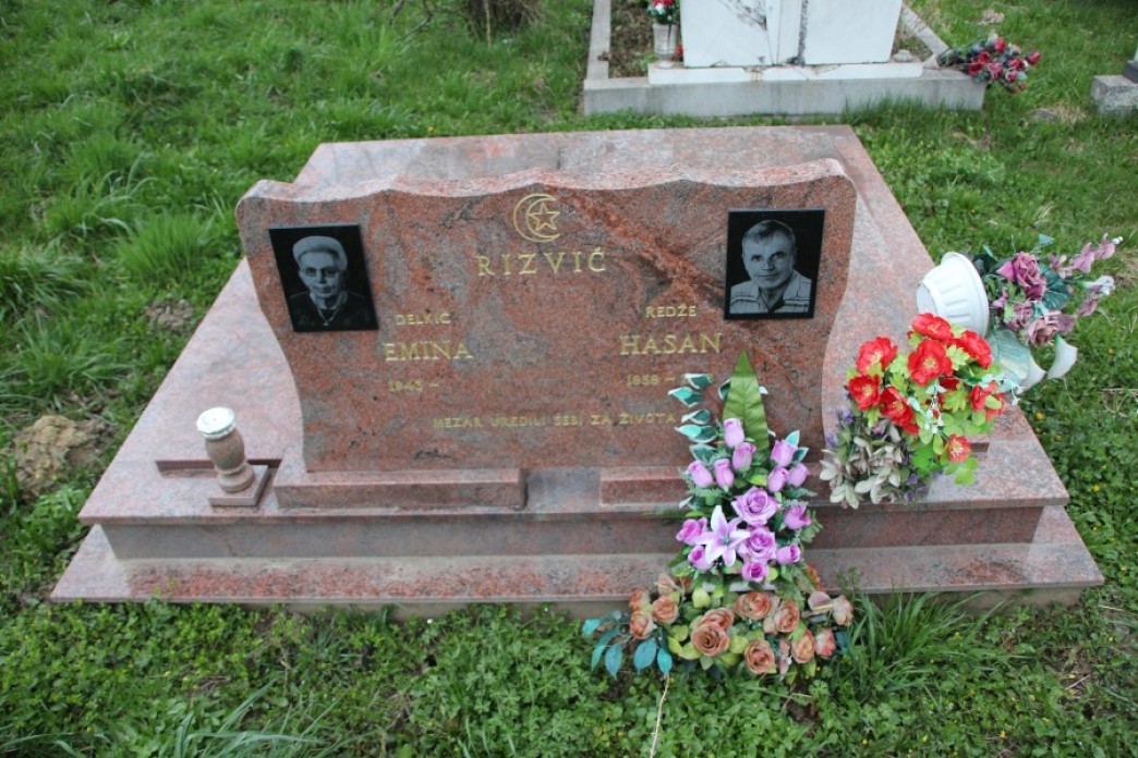 A grave with flowers on it.