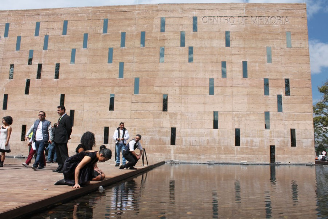 People looking over a reflecting pool.