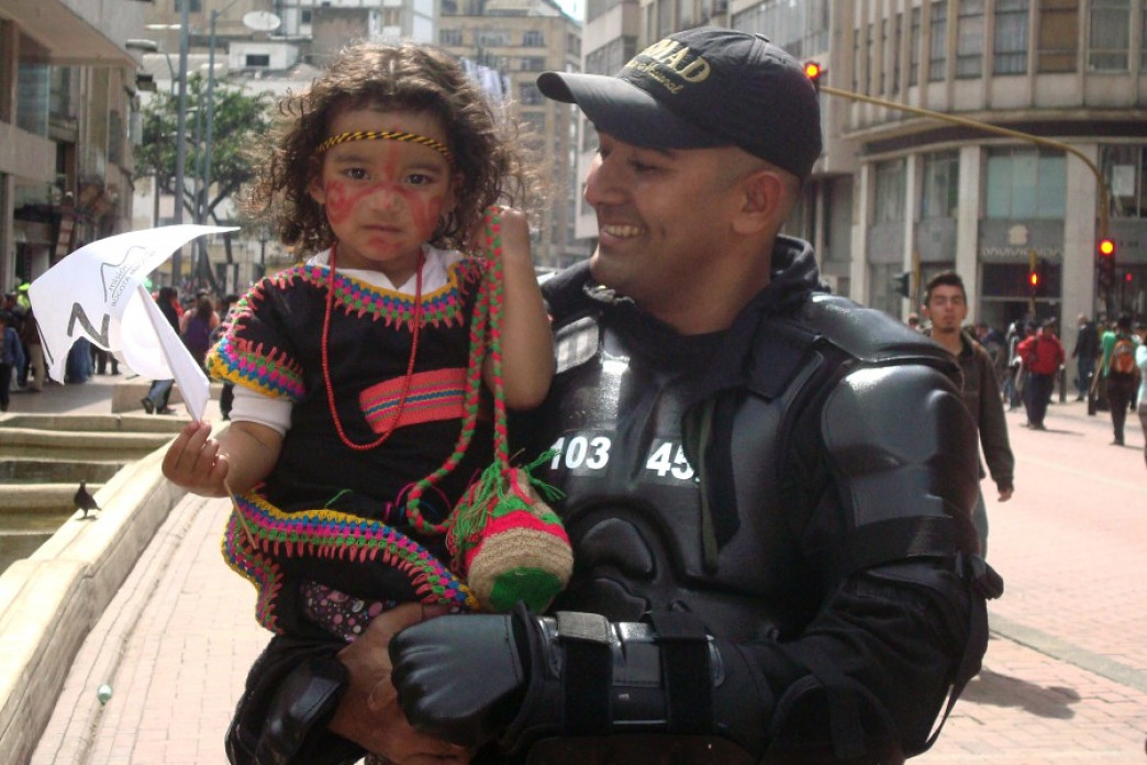 A father holding his young daughter at a march.
