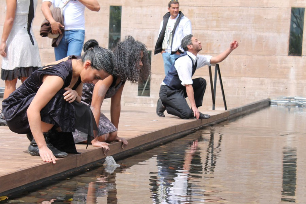 People looking over a reflecting pool.