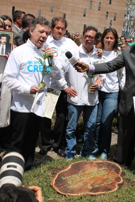People gathered around a wood plaque.