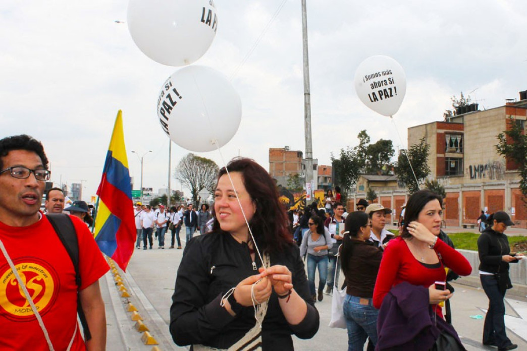 People holding balloons at a march.