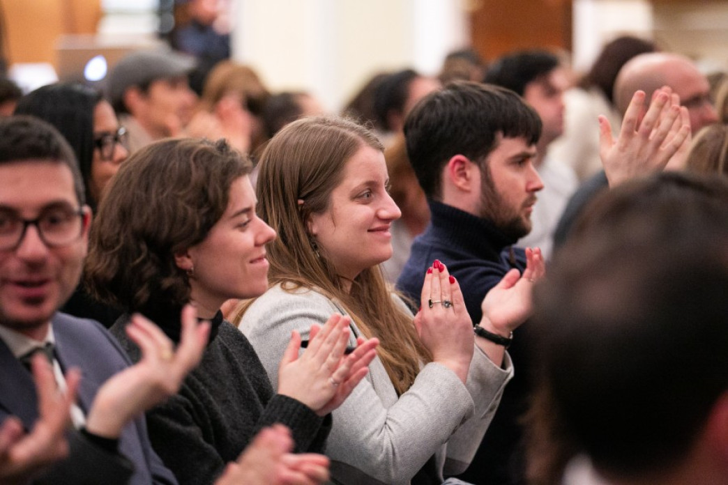 People applauding at a lecture.